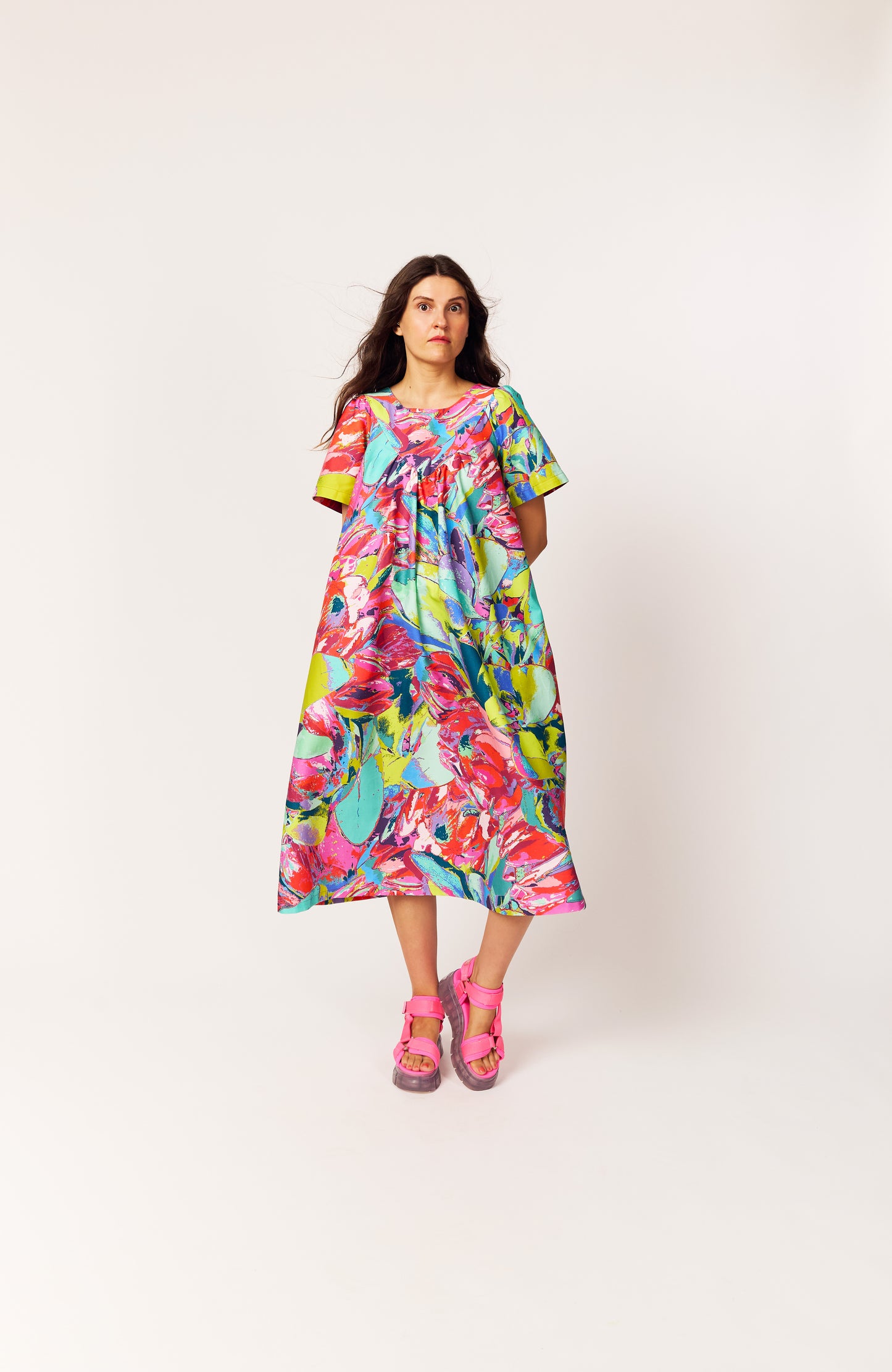 Lanya wearing The Debut Dress in Protea Painterly print – colourful maximal organic cotton midi dress with flowing silhouette.