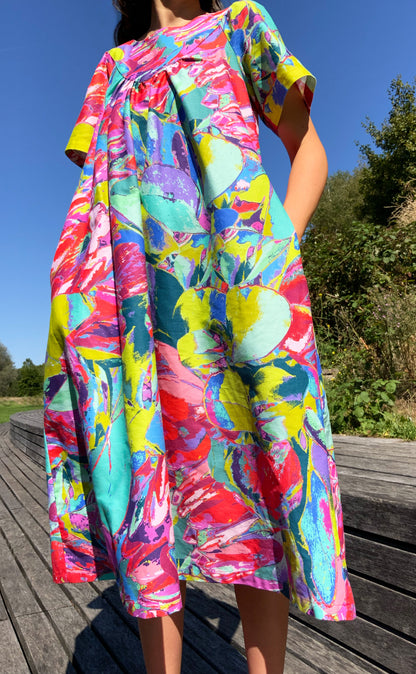 The Debut Dress by LANYA studio in Protea Painterly print – colourful maximal organic cotton midi dress with flowing silhouette, in a vibrant multicoloured pattern.